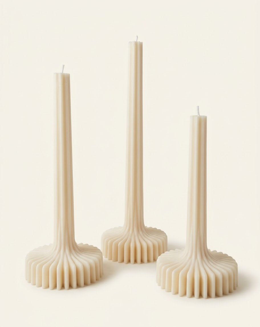 Beige Bloom Elegance candles with tall ribbed stems and fluted round bases.