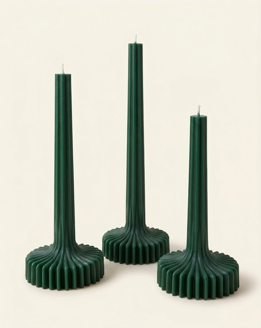 Green Bloom Elegance candles with tall ribbed stems and fluted round bases.
