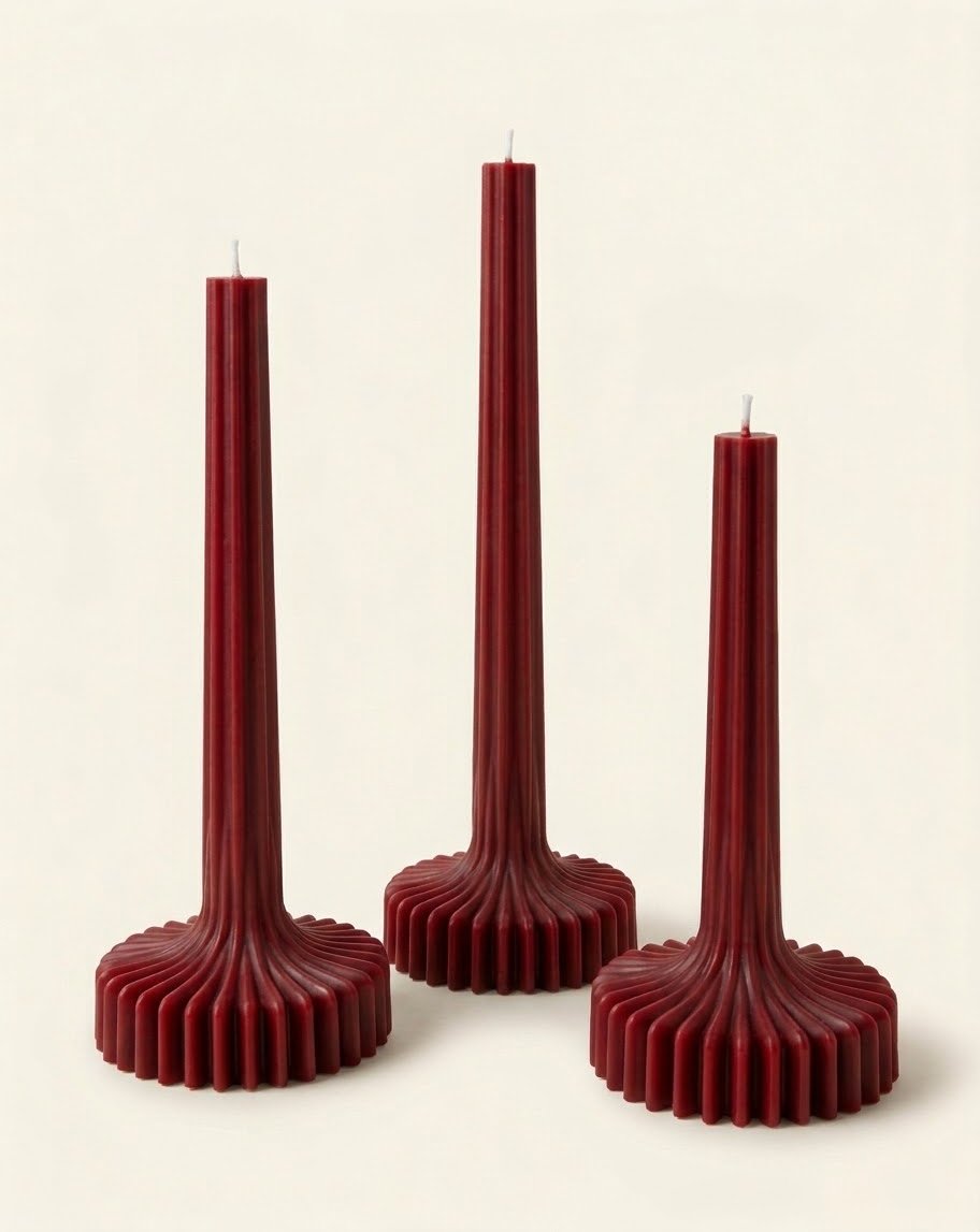 Red Bloom Elegance candles with tall ribbed stems and fluted round bases.