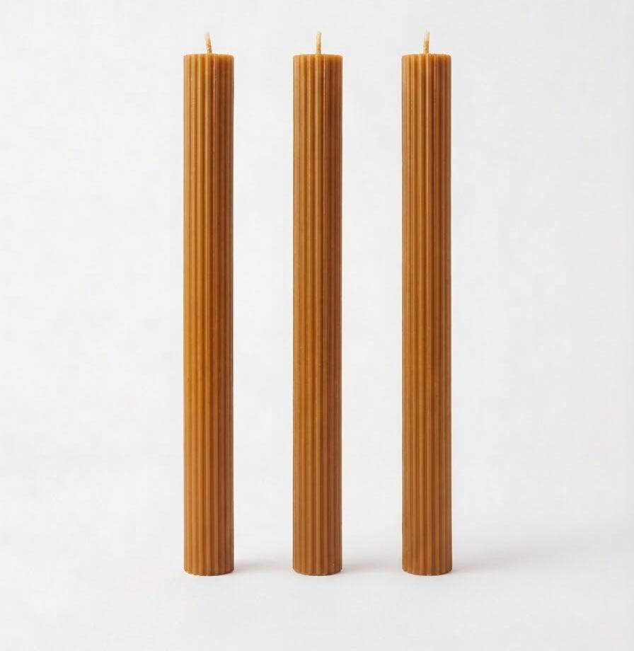 Caramel-colored Linear Elegance candles with straight sides and vertical ribs.
