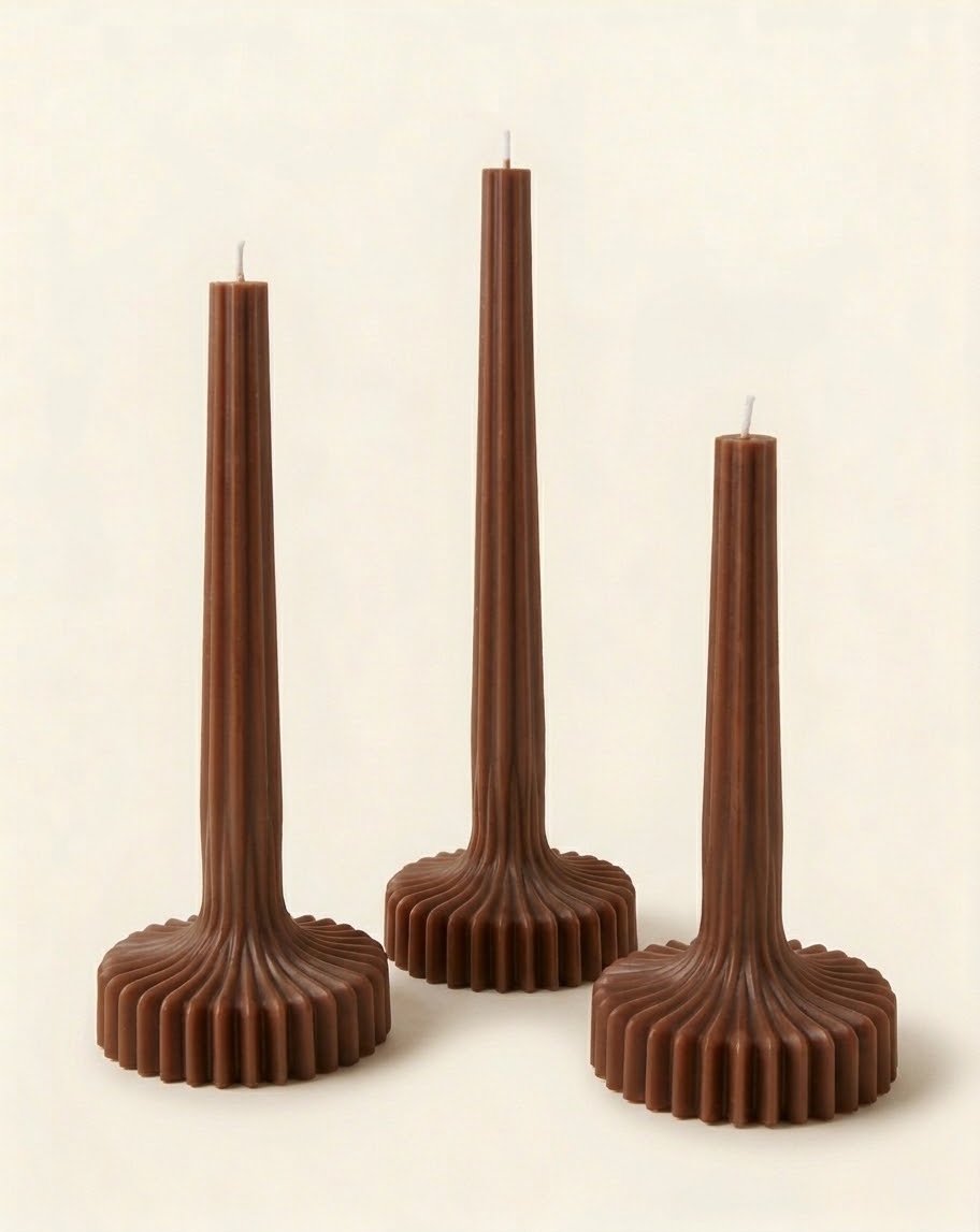 Brown Bloom Elegance candles with tall ribbed stems and fluted round bases.
