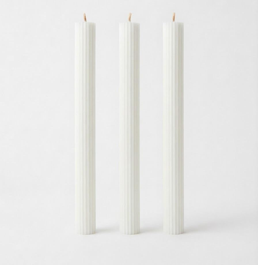 White Linear Elegance candles with straight sides and vertical ribs.