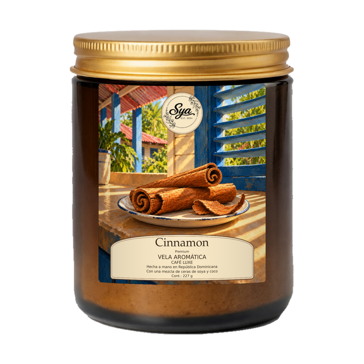 Vela Sya Cinnamon de Café Luxe en frasco ámbar con tapa dorada y etiqueta Cinnamon ilustrada.