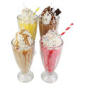 Four Creamy Milkshake candles shown together in glasses, with cream-like swirls and colorful decorations.