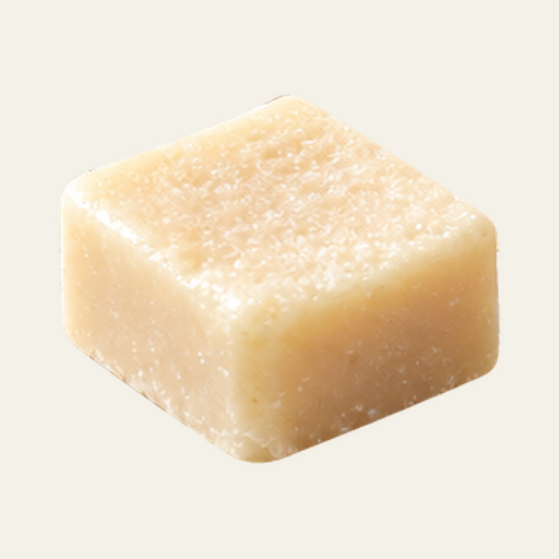 Cream-colored Dulce de Leche wax melt with a square shape and a finely textured surface.