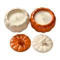 Velas Pumpkin Charm color crema y naranja en frascos con forma de calabaza, con tapas del mismo color colocadas al lado.