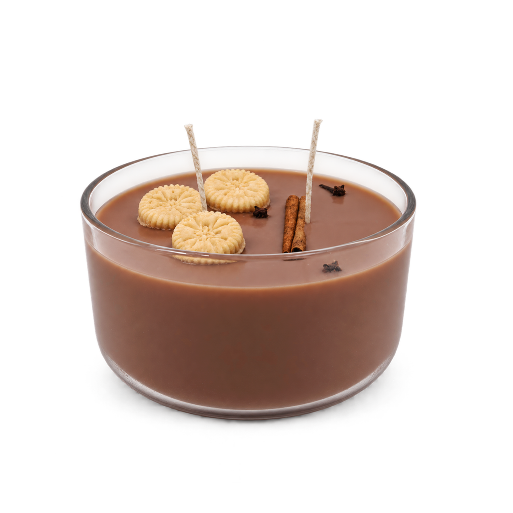 Habichuelas con Dulce candle in a round glass bowl with brown wax and biscuit-shaped decorations.