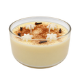 Pale yellow Majarete candle in a round glass bowl, with cream-colored decorations and brown speckles.