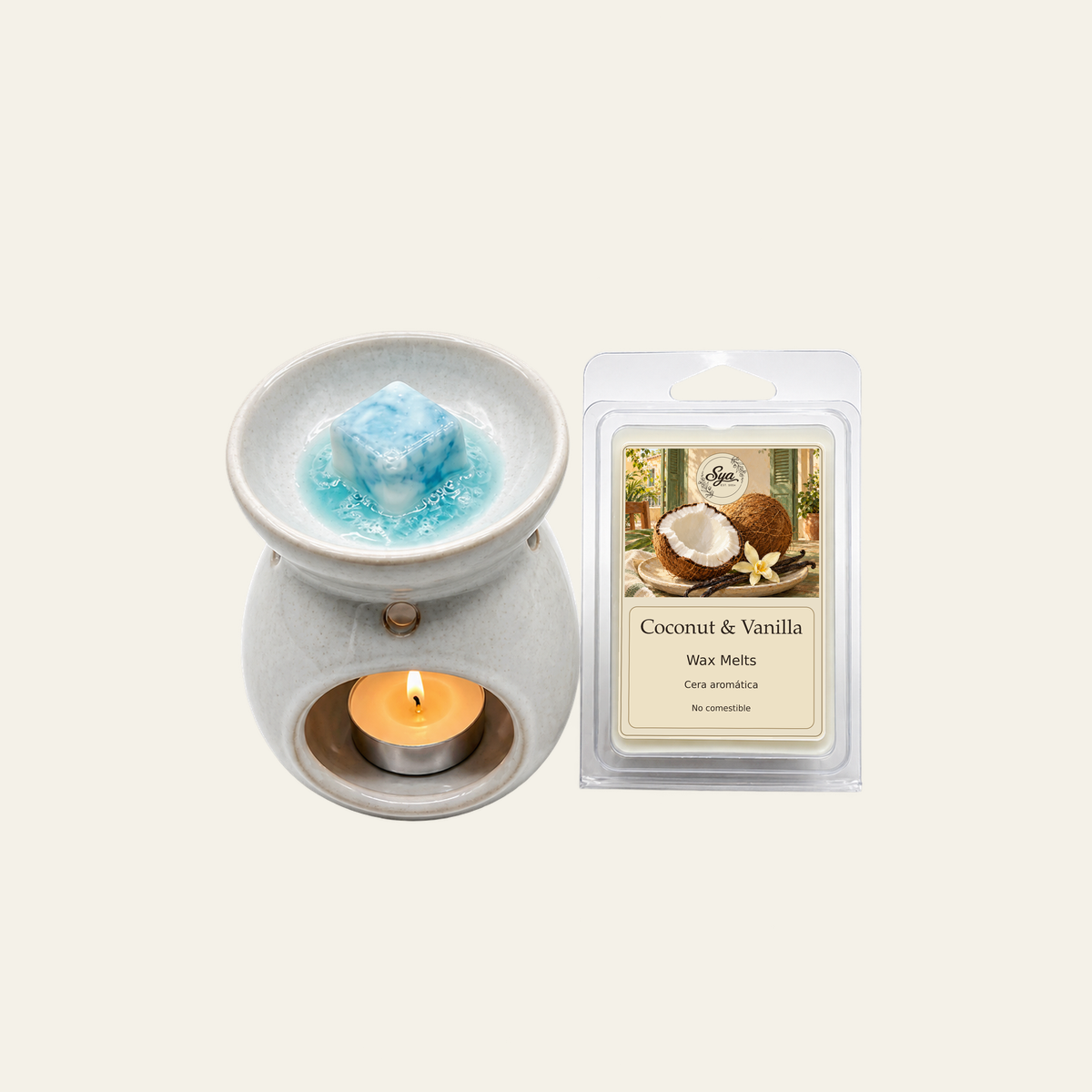Gray wax warmer with blue wax and a lit tealight beside a Coconut & Vanilla wax melt packet.