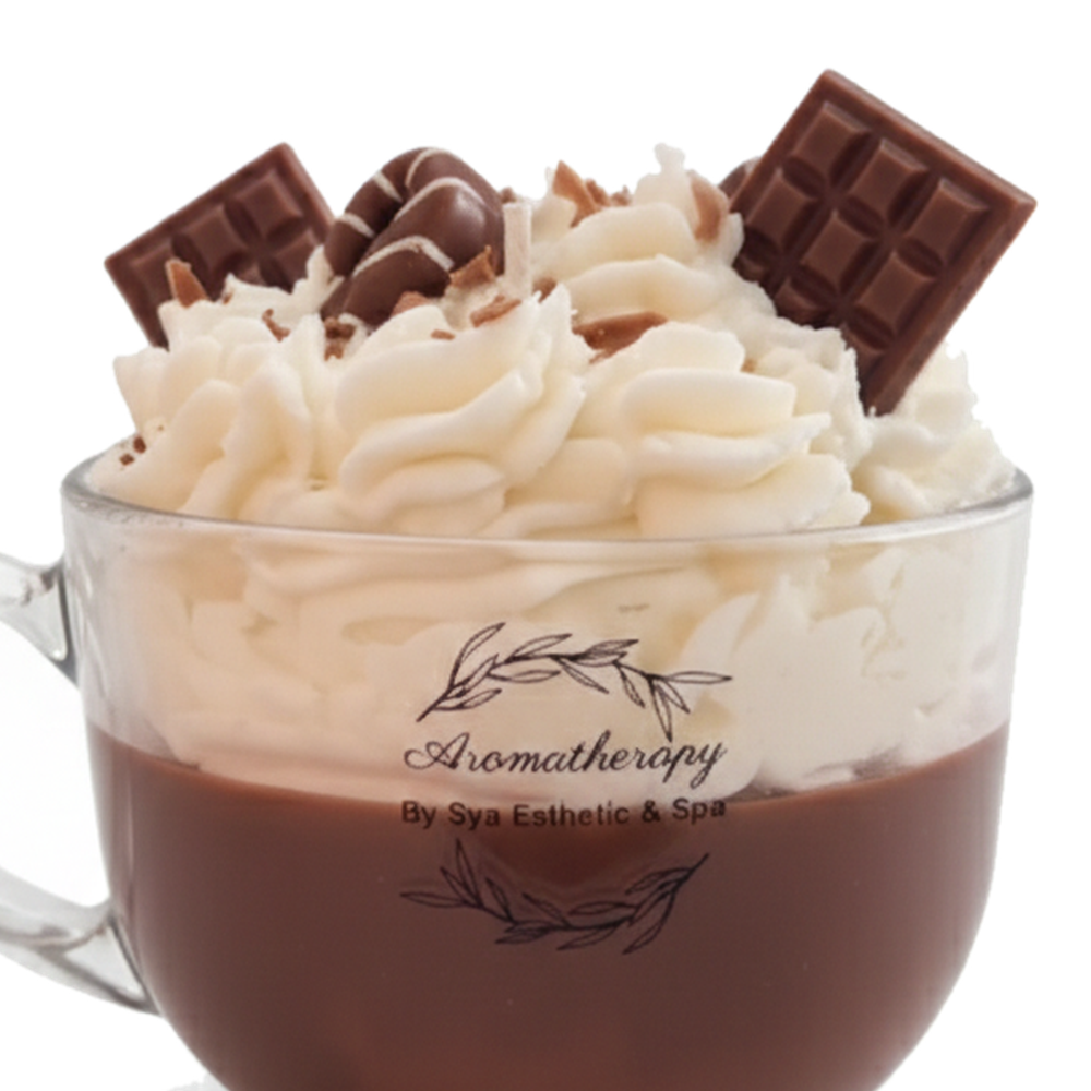Mocaccino candle close-up with cream-colored swirls and chocolate-shaped decorations in a glass mug.